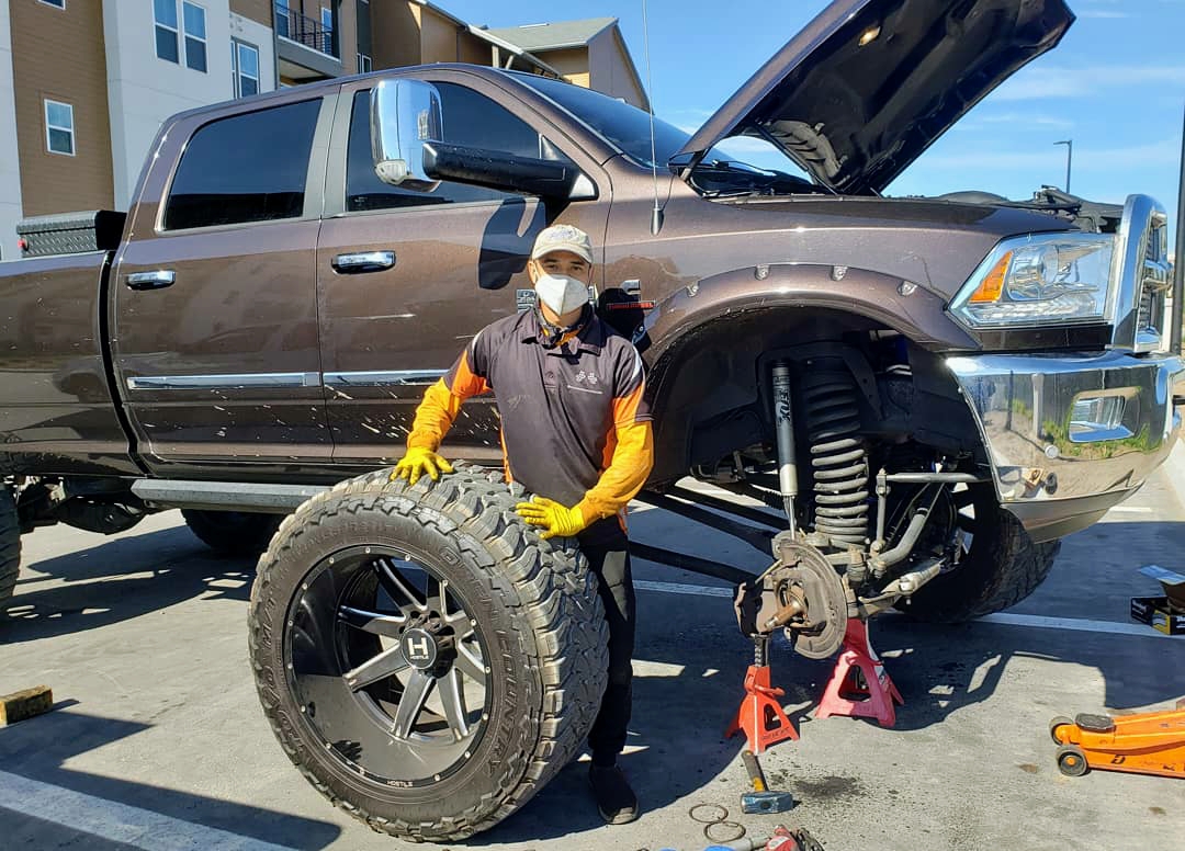 Gold Wrench Mobile Mechanic working on a lifted truck