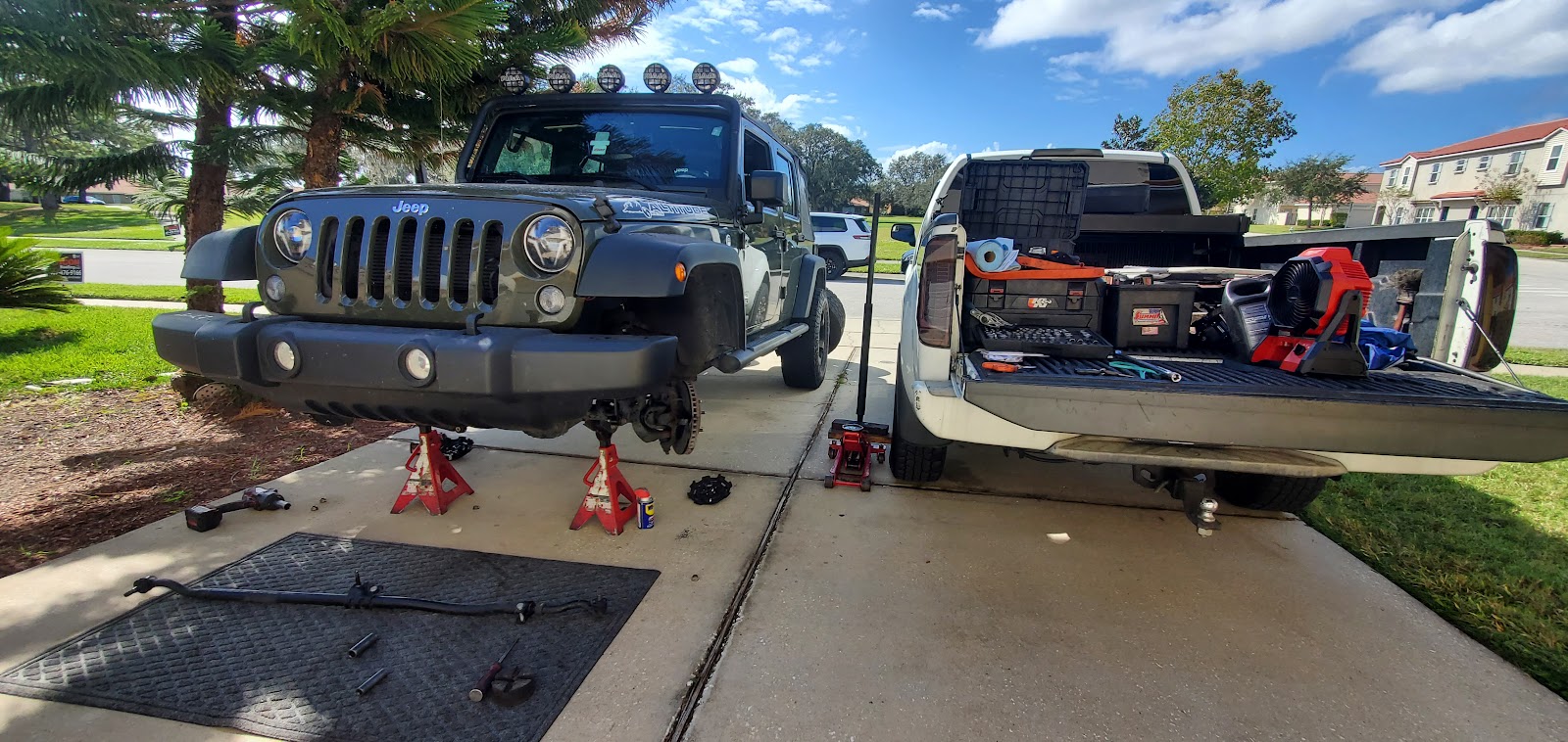 Multiple vehicles being serviced in a driveway